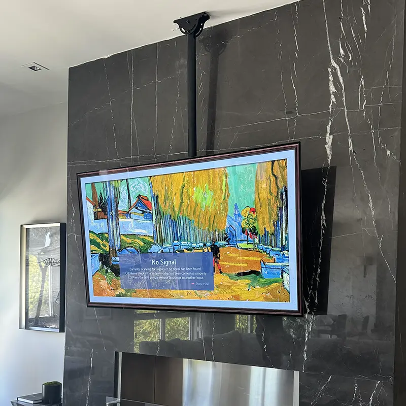 TV ceiling-mounted above marble fireplace to protect the surround from drilling