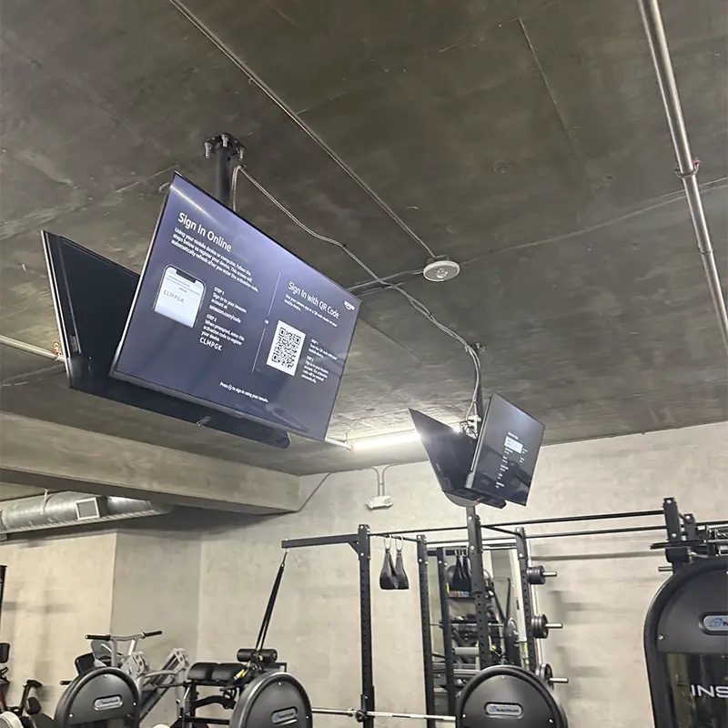 TV ceiling-mounted in home gym on concrete ceiling, the only viable install option