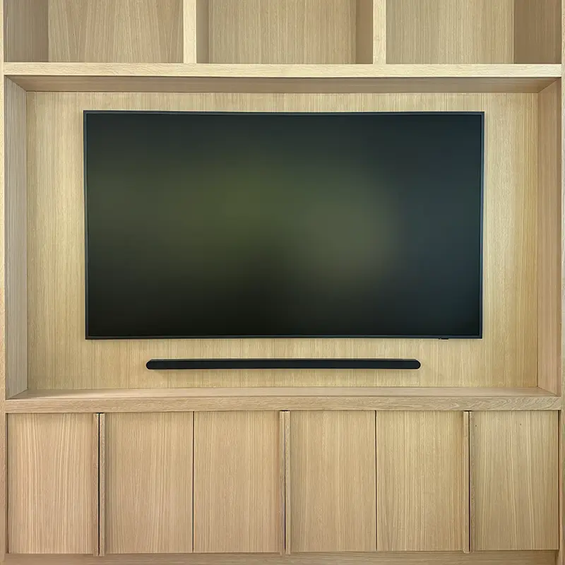 75-inch Samsung Frame Pro TV mounted in custom built-in cabinets with hidden One Connect Box and soundbar