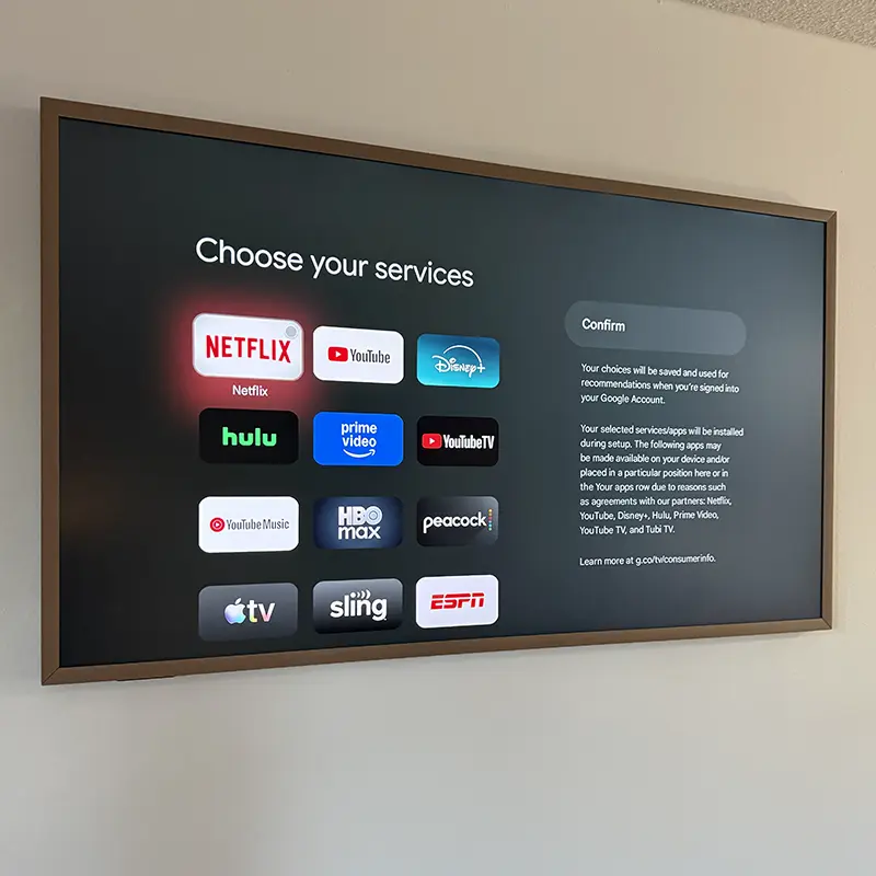 65-inch Hisense CanvasTV mounted on wall with gallery-style look, no visible cords