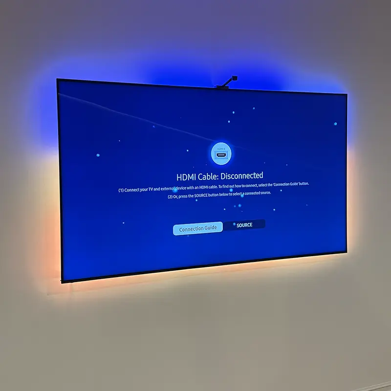 TV with custom smart LED backlighting in blue and yellow, app-controlled colors