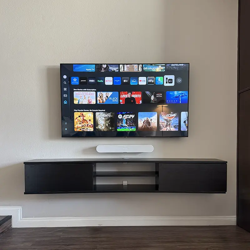 Wall-mounted Hisense TV with slim black soundbar below, clean cable-free install