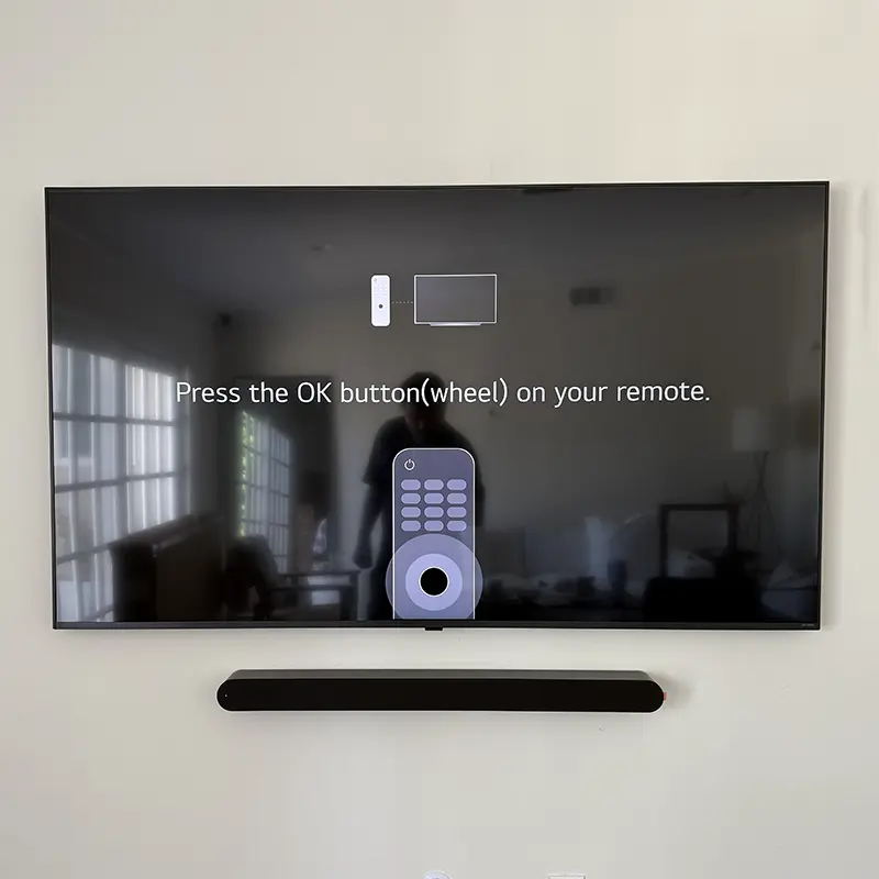 Wall-mounted TV with Sonos soundbar and floating media console, all cables hidden