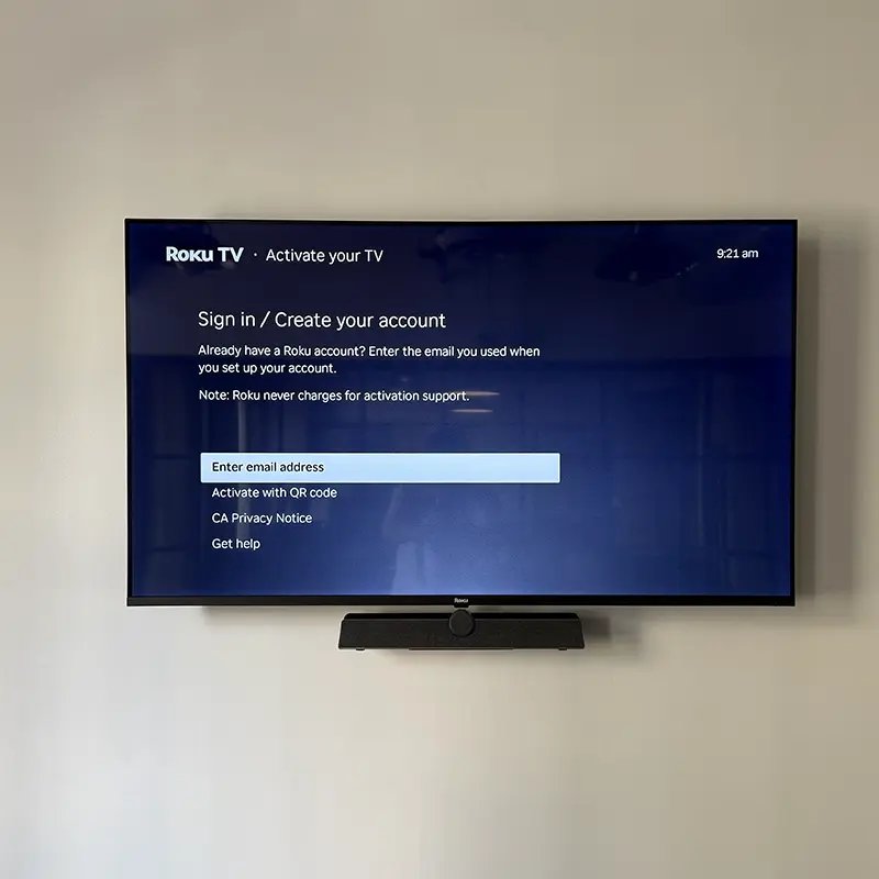 75-inch office TV with Sonos soundbar and video conferencing camera, no visible wires