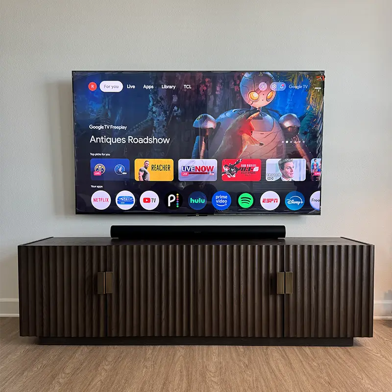 TV with soundbar above media console, all cables hidden inside the wall